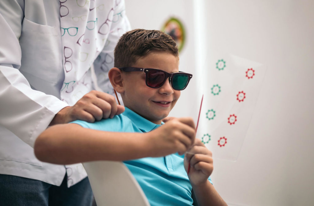 A young boy in a blue collared shirt undergoing vision therapy.