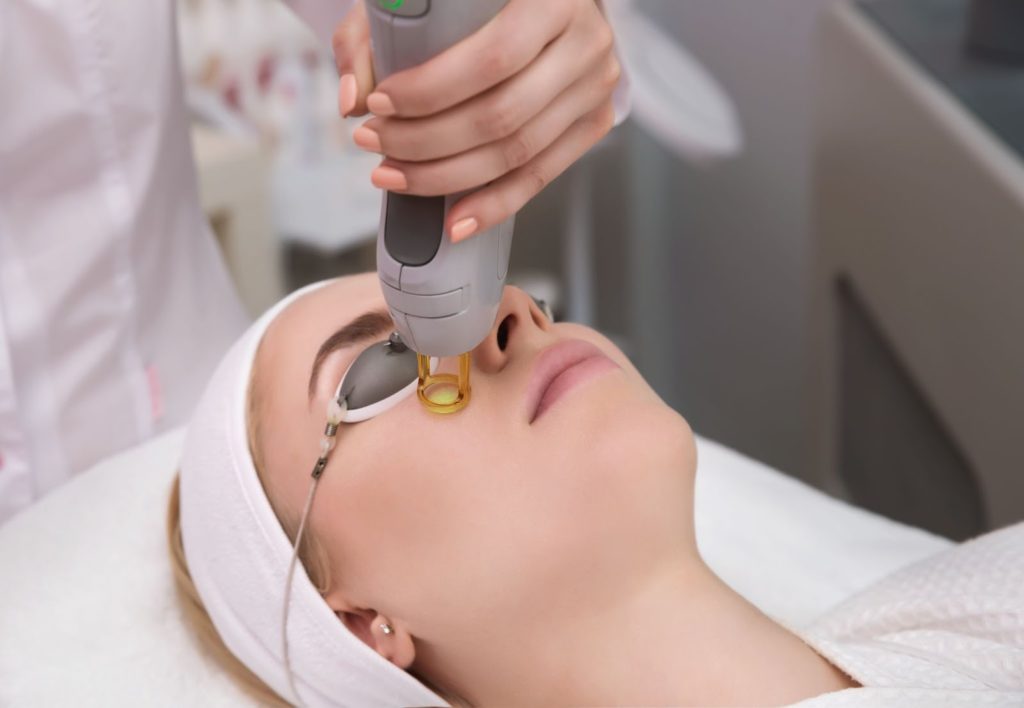 A woman getting an IPL treatment for her dry eye syndrome.